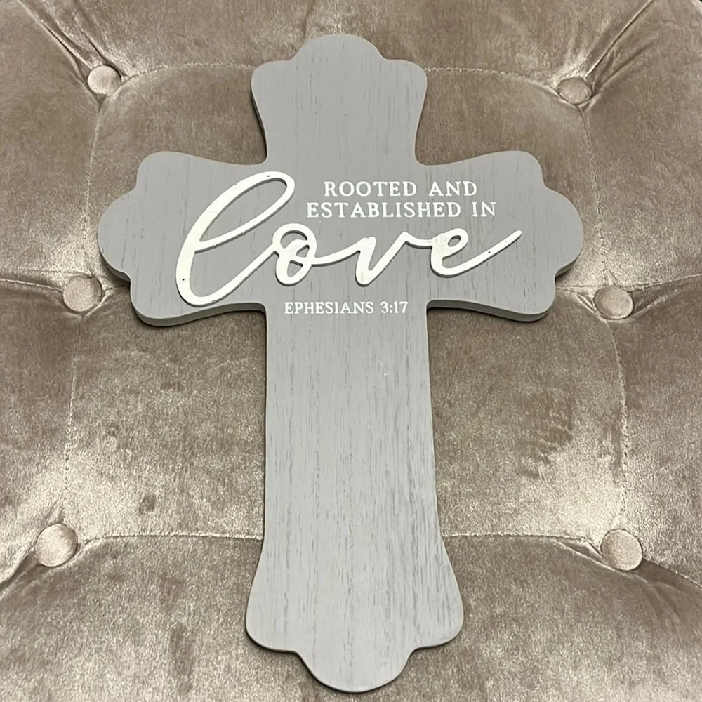 Gray wooden cross with white printing, rooted and established in love, Eph 3:17